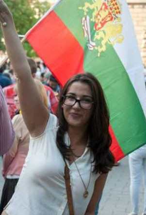 Дъщерята на авторката, Надя Маринова, развява националния флаг на протеста в София на 2 юли т.г.. Снимка: Калина Маринова