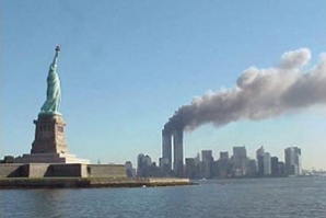 Кулите-близнаци на Световен търговски център горят, след като Полет 11 на „Американ Еърлайнс“ удря Северната кула, а Полет 175 на „Юнайтед Еърлайнс“ - Южната.
