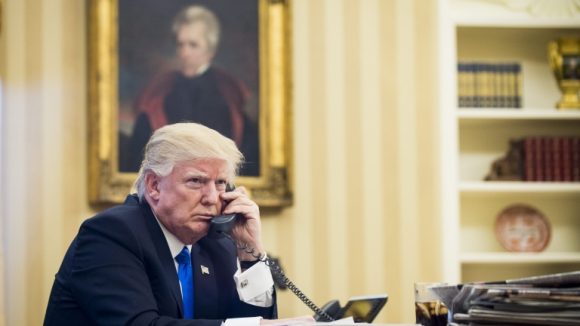 epa05758037 US President Donald J. Trump speaks on the phone with Prime Minister of Australia, Malcolm Turnbull, in the Oval Office in Washington, DC, USA, 28 January 2017. The call was one of five calls with foreign leaders scheduled for 28 January. EPA/PETE MAROVICH / POOL